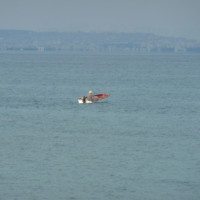 Man in a small motorboat in front of Antalya